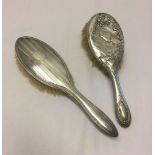 2 silver backed hairbrushes. One with engine turned decoration. Both Birmingham hallmarks. 1928