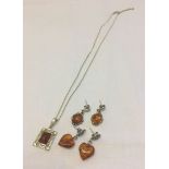 A pretty 925 silver pendant with amber centre on silver chain, together with a pair of silver