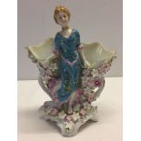 A Meissen style twin posy vase with a figure of a lady and flower decoration.
