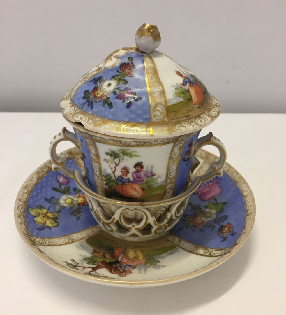 An 18th century Dresden (Meissen) lidded chocolate cup and trembluese saucer. Bears underglaze