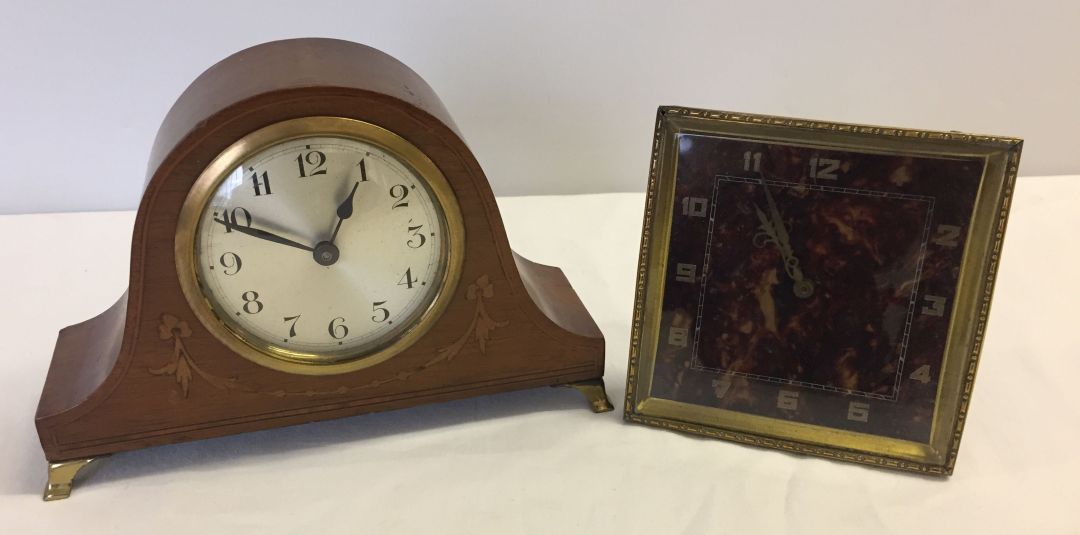 A brass clock with tortoiseshell effect face together with a small wooden cased mantle clock.