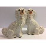 A pair of Victorian Staffordshire Spaniel dogs one a/f approx 33cm high.