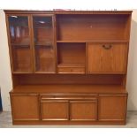A large modern teak sideboard unit with glass doors, cupboards and drawers. Approx 178 x 172cm.