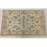 A 100% wool rug in neutral colours made in Jaipur, India. Size approx 91 x 150cm.