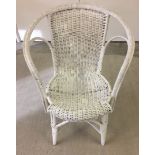 A white painted cane armchair.