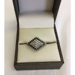 Ladies 9ct gold dress ring set with black and white diamonds in a diamond shaped mount. Size P.