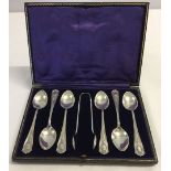 A set of silver plated teaspoons & sugar tongs.