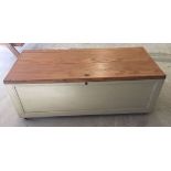 Large pine blanket box/coffee table. Painted sides and back with natural wood finish top. 142cm wide