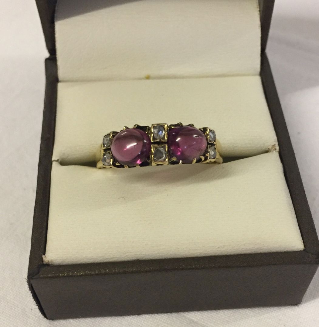 Antique 18ct gold ring set with 6 diamonds and 2 large ruby cabouchon stones. Maker Betts & Fairfax.