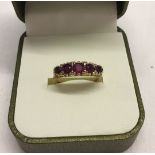 A 9ct gold ladies dress ring, set with 5 rubies. Size M1/2 total weight 2.9g.