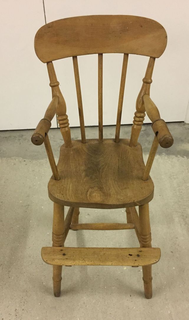 A stick back vintage pine childs high chair.
