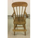 A stick back vintage pine childs high chair.