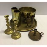 A box of brassware to include candlesticks & shell casing.