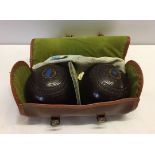 A set of lawn bowls in carrying case.