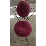 A decorative metal framed boudoir chair with pink rouched velour upholstery