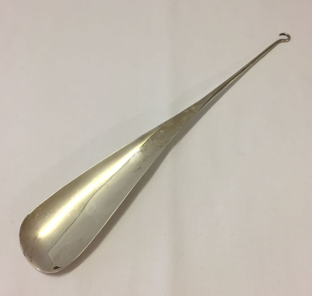 Silver shoehorn with hooked end to use as a button hook. Hallmarked Birmingham 1913. 270mm long,