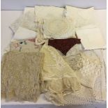 A quantity of vintage lace and linen to include Damask tablecloth, doylies, etc.