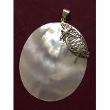 A mother of pearl shell pendant witht 925 silver bale and dragonfly motif.