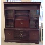 A modern dark mahogany coloured sideboard with glass door cupboards. Approx 167 x 192cm.