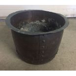 A large riveted copper tub.