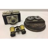 A German manufactured camera and a pair of French opera glasses together with a vintage plastic