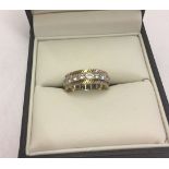 A 9ct gold full eternity ring set with clear stones and diamond cut decoration to edges. Size K1/