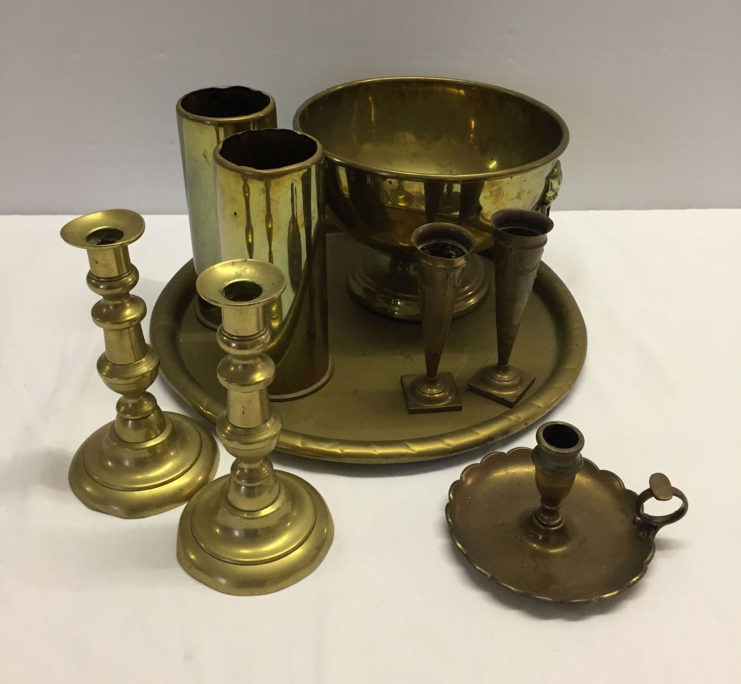 A box of brassware to include candlesticks & shell casing.