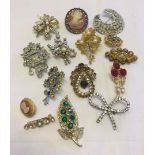 A collection of costume brooches to include stone set.