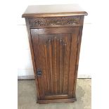 A modern 'Old Charm' style CD storage cupboard with carved detail to front. Approx 36 x 82cm.