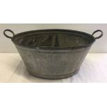 A galvanised wash tub.