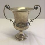 A silver 2 handled urn by Garrard, London 1924, 12cm tall, approx 158.9g, 2 dents to lower part of