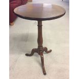 A Georgian oak tripod wine table on padded feet, approx 73cm high.