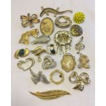 A quantity of gold tone costume brooches to include Hollywood.