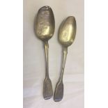 A pair of large Georgian silver fiddleback serving spoons.