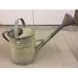 A galvanised watering can with rose. Small dents to rose.