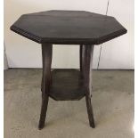 A small dark wood octagonal shaped occassional table.