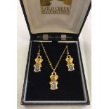 A gold plated necklace and matching earring set in the shape of Koala Bears set with opals.