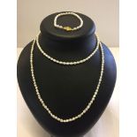 2 freshwater pearl necklaces, one approx 30" and the other 16". Together with a matching bracelet.