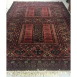 A very large rug in deep red & green colours. Approx 252cm x 372cm.