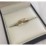 A 9ct gold ladies dress ring. Gold band set with 3 diamonds. Size O. Total weight approx 2g.