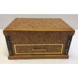 A light wood jewellery box with drawer to front.