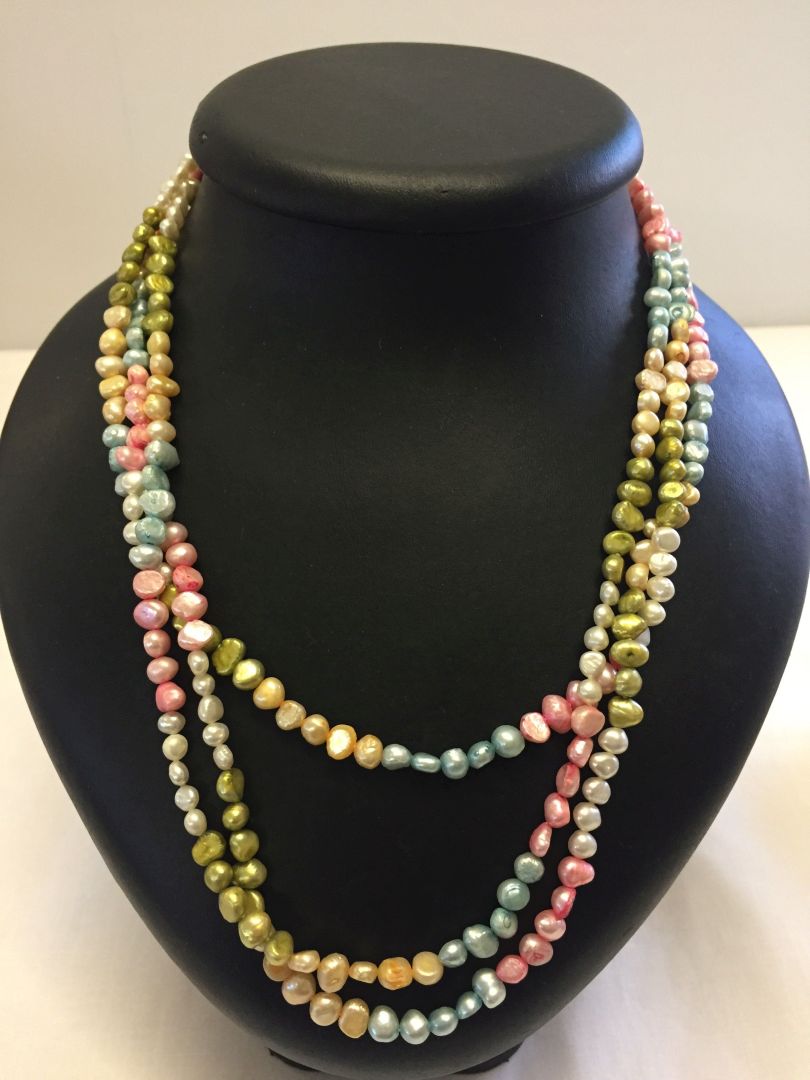 A long string of pastel coloured freshwater pearls measuring approx 68" long.