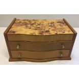A light wood jewellery box with flower design to lid.
