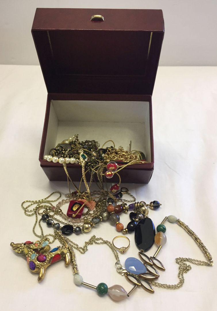 A red box of modern costume jewellery to include Murano glass examples.