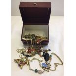 A red box of modern costume jewellery to include Murano glass examples.