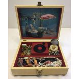 A c1960s musical jewellery box with key. Inside there is a miniature record deck which rotates