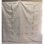 A hand embroidered linen table cloth. Measures approx 117cm x 150cm.
