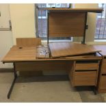 A large modern beech coloured corner desk with metal frame.