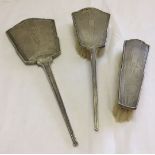 3 silver backed ladies dressing table items. A mirror and 2 brushes. HM Birmingham.