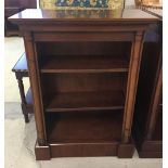 A solid mahogany bookshelf with column design to front and moveable shelves. Approx 71 x 96cm.